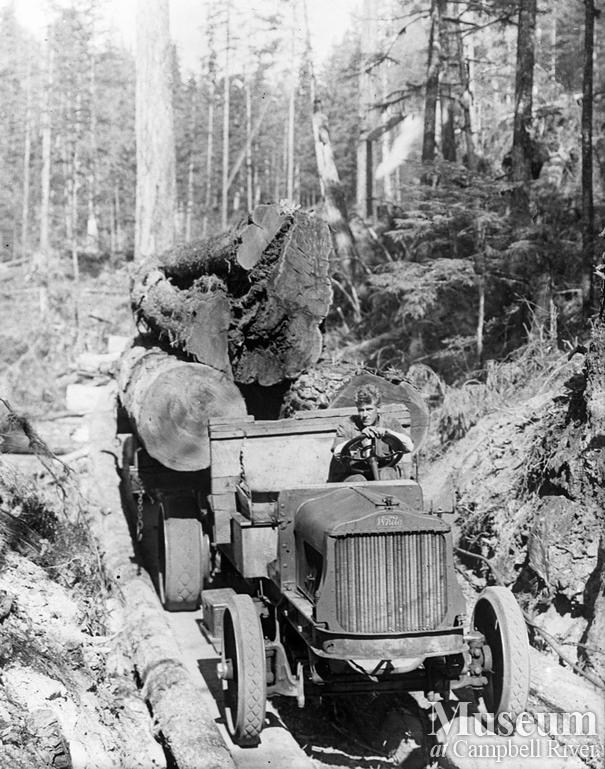 A loaded White logging truck
