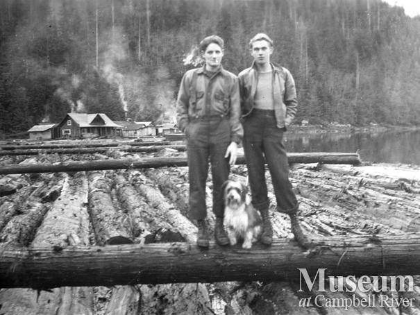 Loggers on boom at Call Inlet